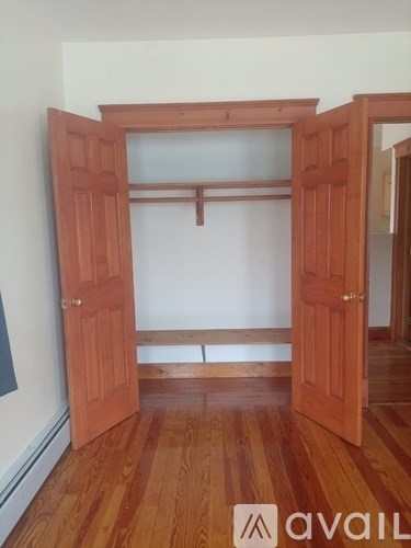 A room with wooden floors and a large open door.