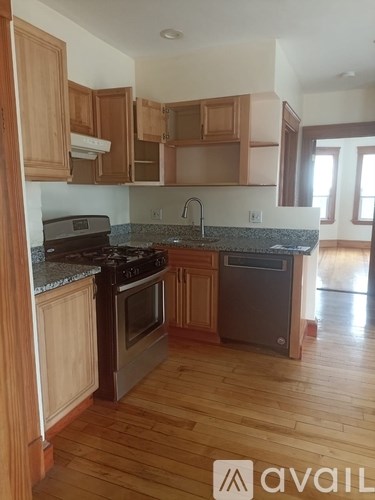 A kitchen with wooden cabinets and a granite countertop.