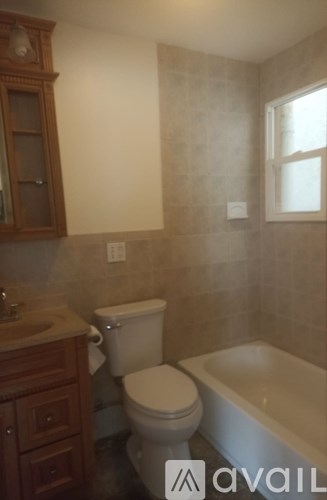 A bathroom with a toilet, sink, and tub.