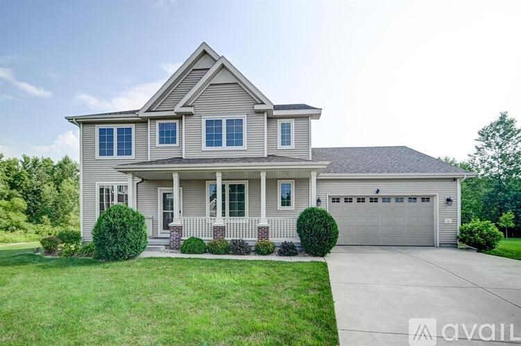 A house with a grey roof and a garage door.