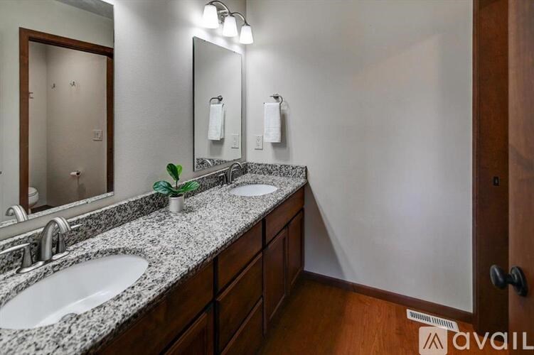 A bathroom with two sinks and a mirror.