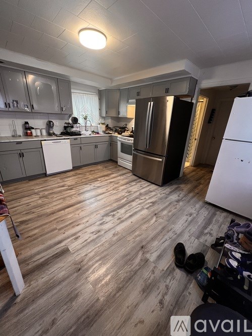A kitchen with wooden floors and stainless steel appliances.