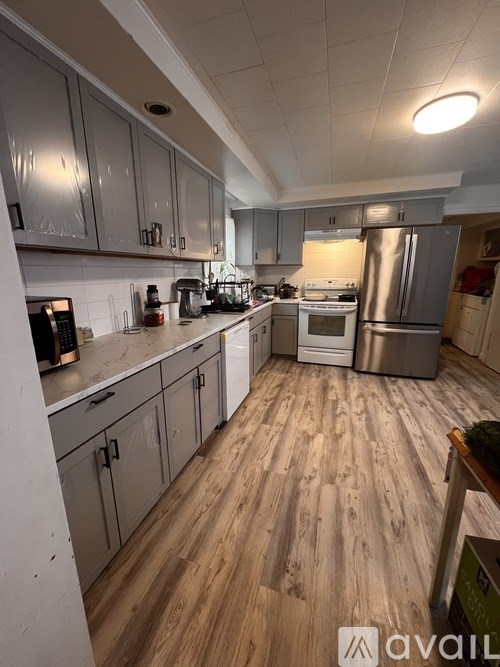 A kitchen with wooden floors and stainless steel appliances.
