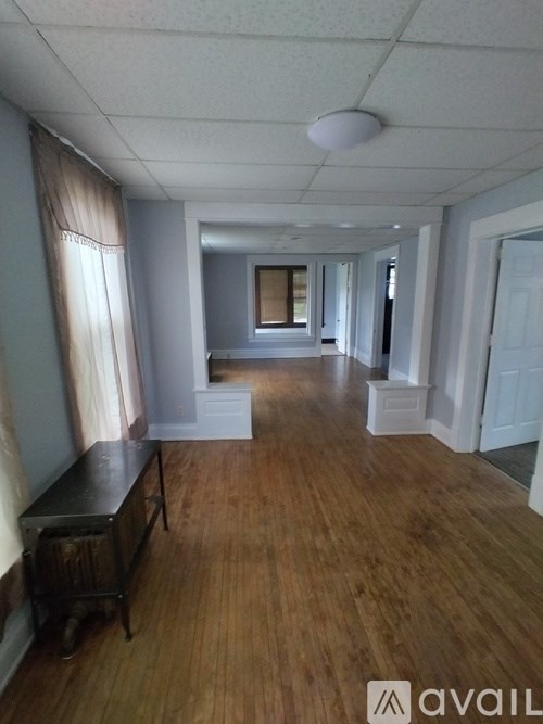 A room with wooden floors and white walls.