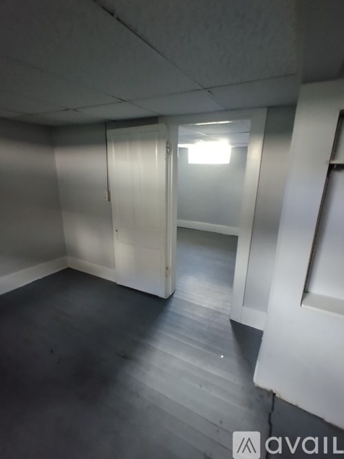 A room with a light on and a door open.