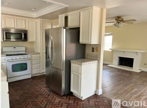 A kitchen with a refrigerator, stove, and oven.