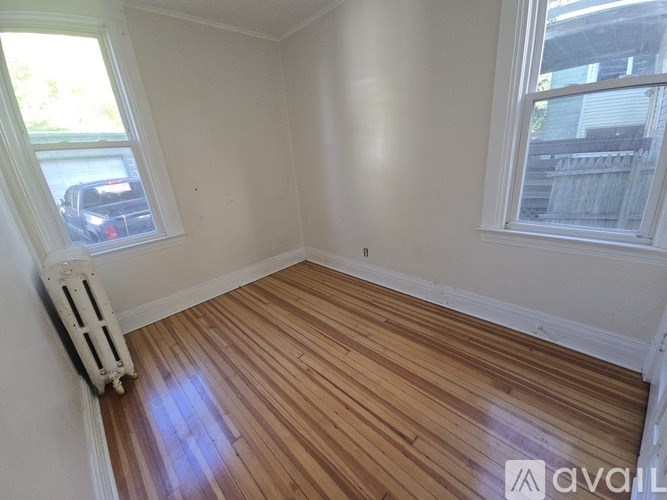 A room with wooden floors and white walls.