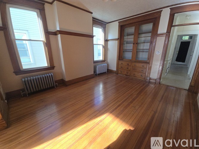A room with wooden floors and a radiator.