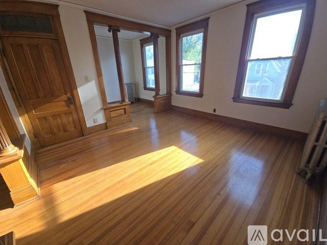 A room with wooden floors and a large window.