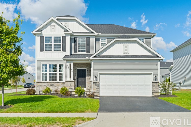 A two-story house with a garage is available for sale.