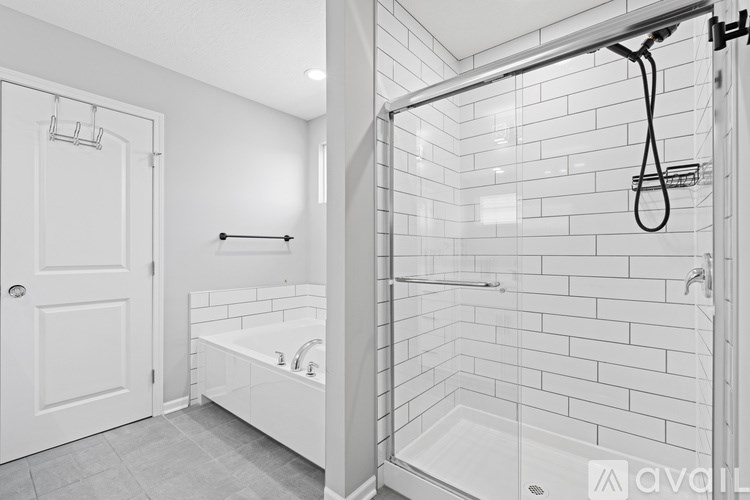 A white bathroom with a walk in shower.