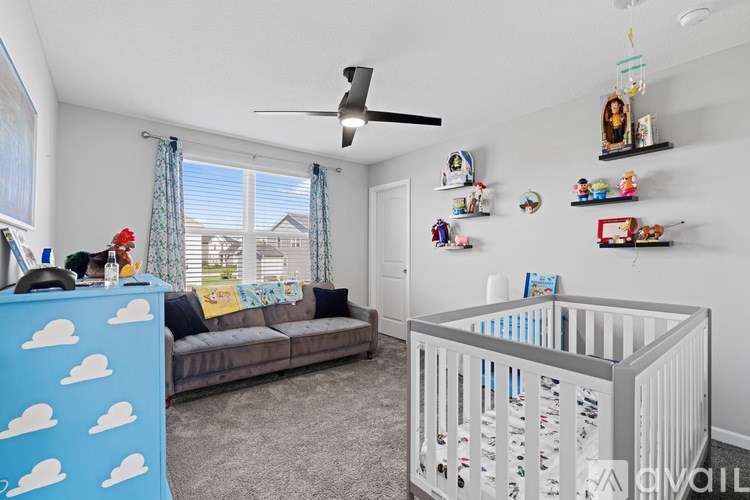 A baby's room with a crib and a sofa.