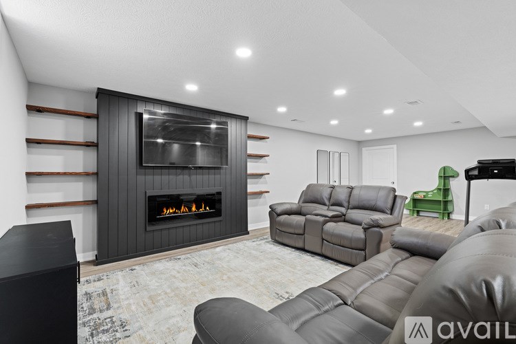 A modern living room with a fireplace and comfortable seating.