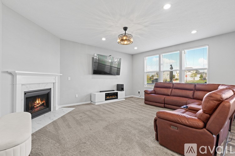 A living room with a fireplace and a television.
