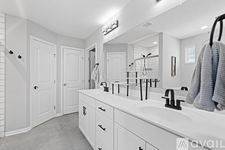 A bathroom with a white sink and a mirror.