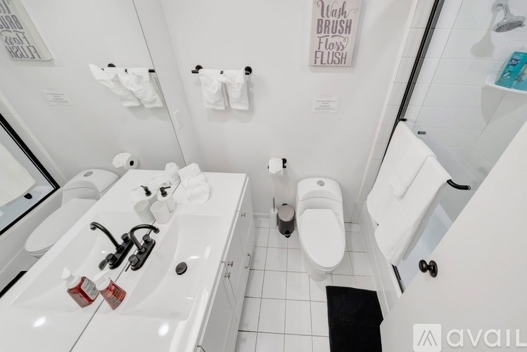 A bathroom with a white toilet, sink, and mirror.