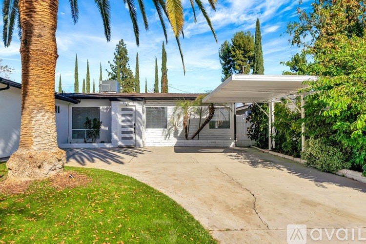A house with a palm tree in front of it.