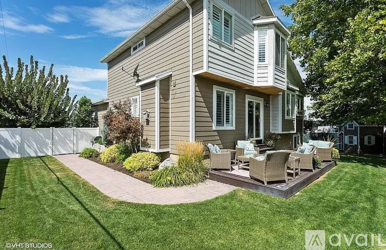 A house with a patio and a white fence.