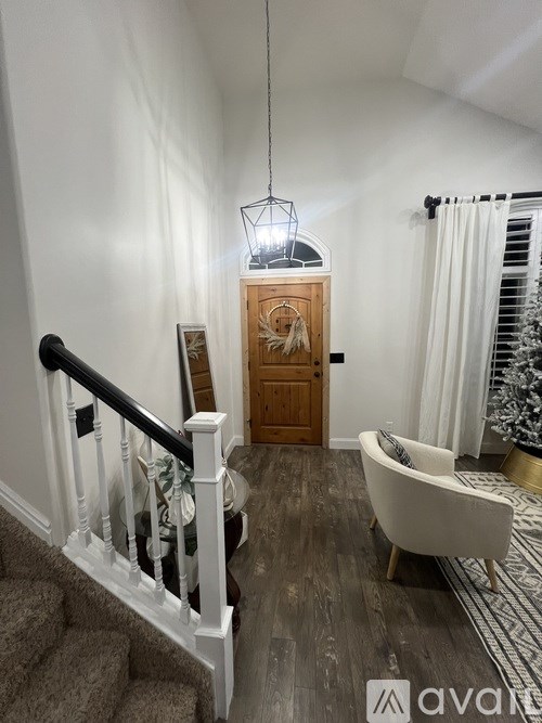 A wooden door with a light hanging above it.