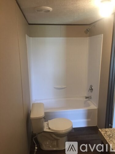 A small bathroom with a toilet, a bathtub, and a sink.