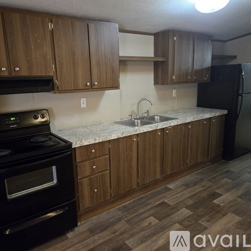 A kitchen with wooden cabinets and a black stove.
