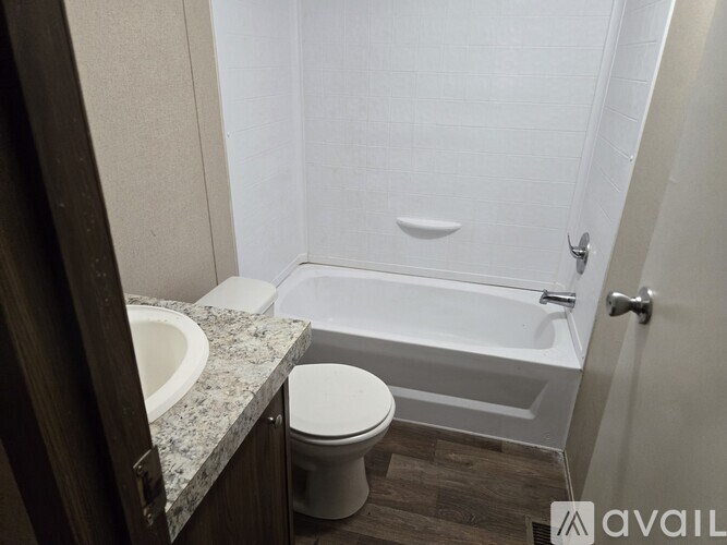 A bathroom with a toilet, sink, and bathtub.