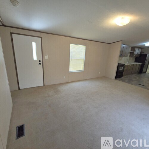 A room with a door, window, and a ceiling light.