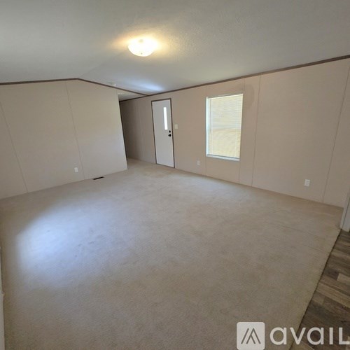 Empty room with a door and a window.