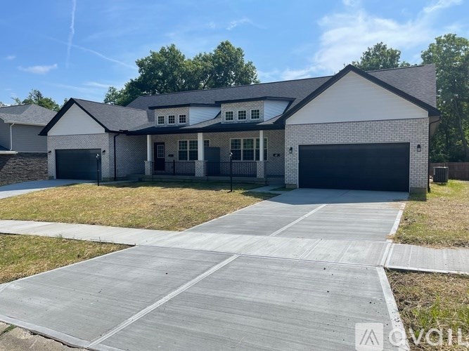 A two-story house with a garage and a driveway.