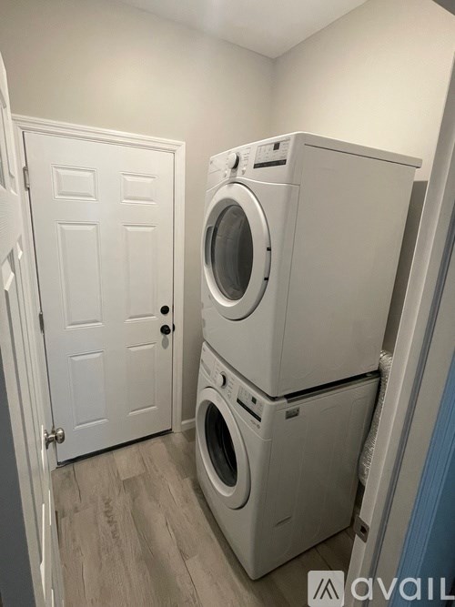 A stack of two washing machines in a laundry room.