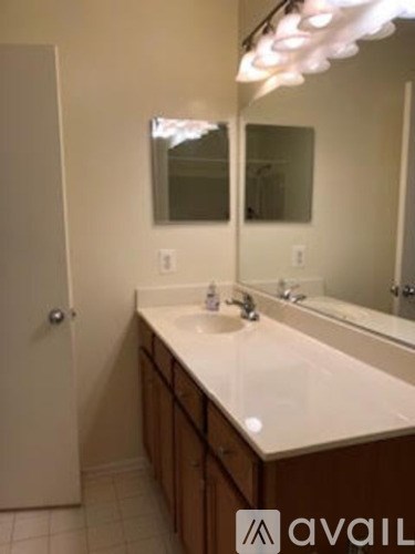 A bathroom with a sink and mirror.