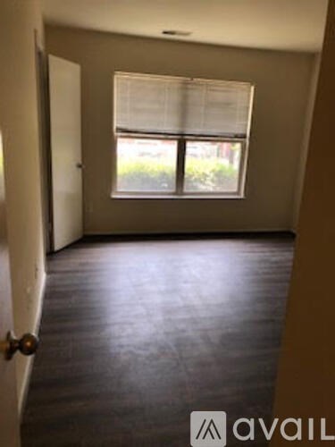 A room with a window and a door.