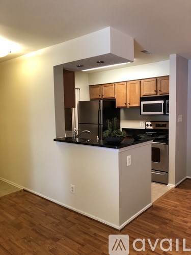 A kitchen with wooden cabinets and a white island.