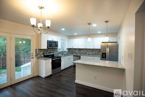 A kitchen with a countertop and a microwave.