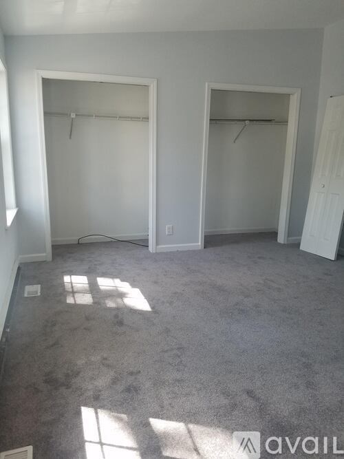 Two empty rooms with white closets and carpeted floors.