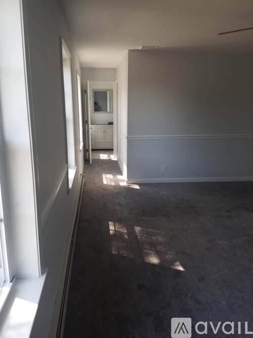 A long hallway with sunlight coming through the window.