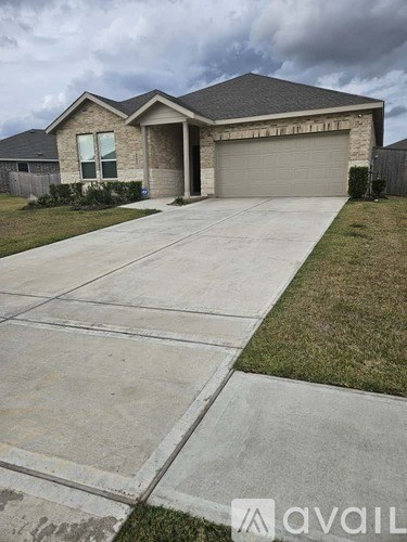 A house with a grey garage door and a driveway in front.