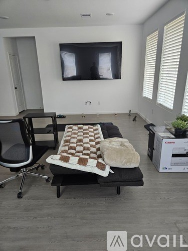 A room with a chair, a table, and a box with the word "avail" on it.