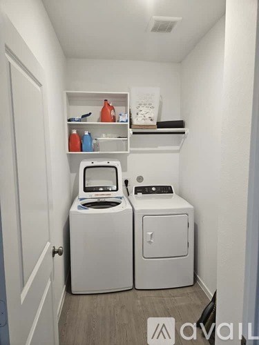 A small laundry room with a washer and dryer.