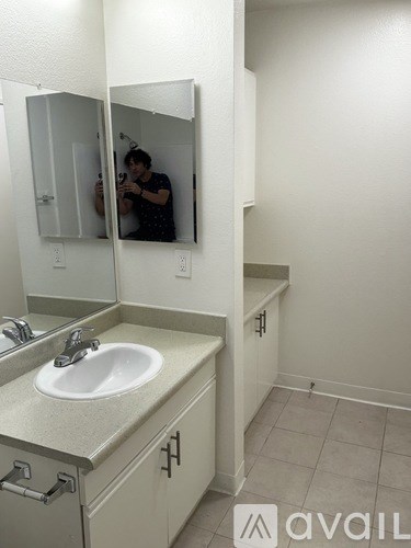A man is taking a picture in a bathroom mirror.
