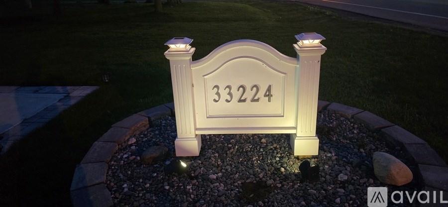 A white house number sign with the number 33224 on it.