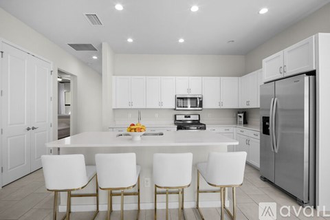 A modern kitchen with white cabinets and a center island.