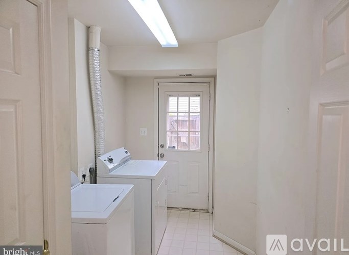 A small bathroom with a toilet, sink, and window.