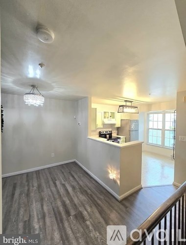 A well-lit room with a reception desk and a Christmas tree in the corner.