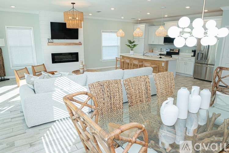 A modern dining room with a glass table and chairs.