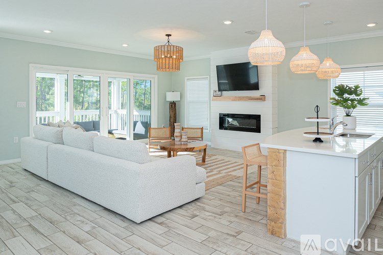 A living room with a white couch and a fireplace.