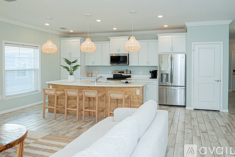 A kitchen with a white couch in front of it.