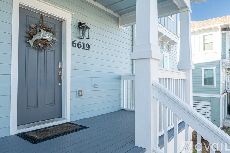 A blue house with the number 6619 on the front door.