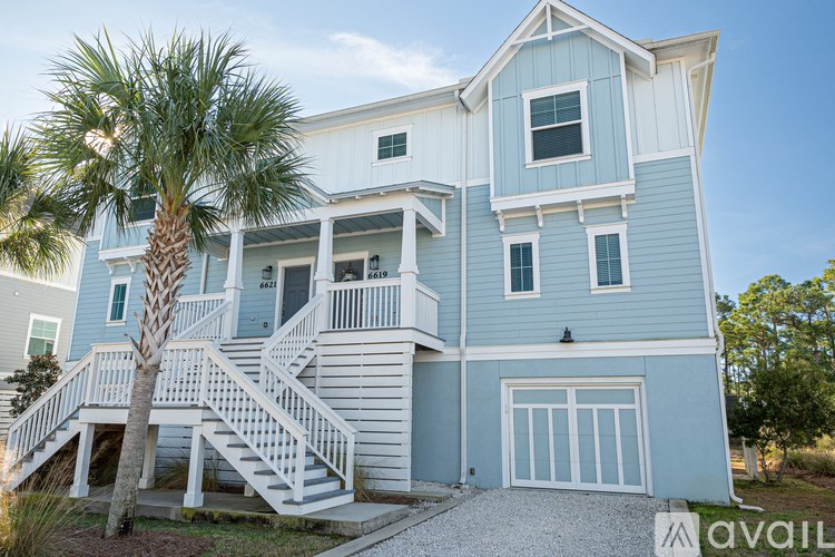 A two-story house with a blue exterior and white trim.