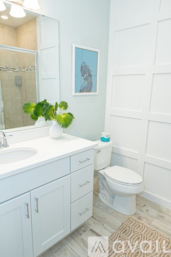 A white toilet sits next to a sink in a bathroom.